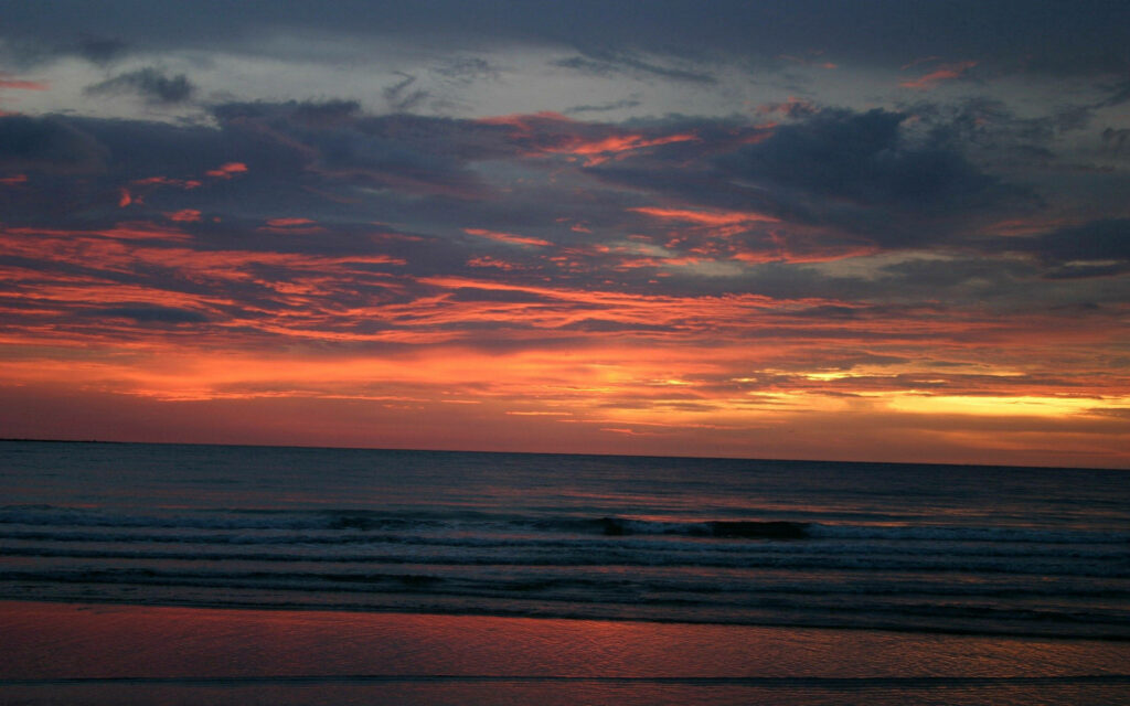 Serenity Unveiled: Capturing the Majestic Tapestry of Dusk Over a Tranquil Sea Wallpaper