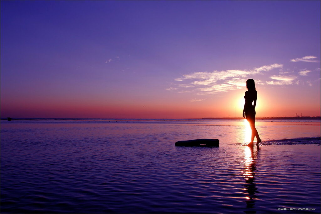 Free-Spirited Beauty: Basking in Sunlight by the Sea Wallpaper