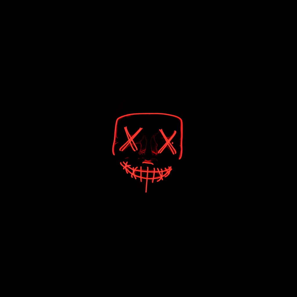 Neon-Lit Red Mask in Dark Background Wallpaper