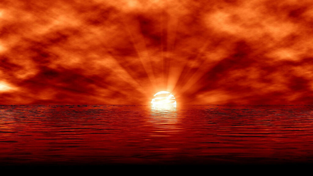 Fiery Skies: A Captivating Red Sun Wallpaper Setting Over the Serene Seas
