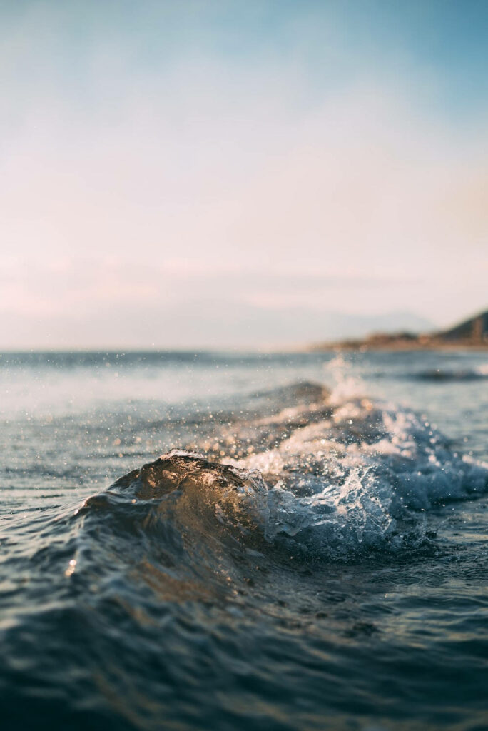 Serene Seascape: Captivating Closeup of Calm Waves Embracing the Coastline Wallpaper