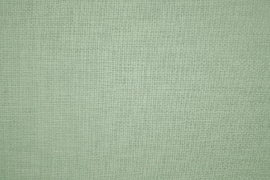 Minimalist sage green textile wallpaper with woven fabric texture for calm digital workspace