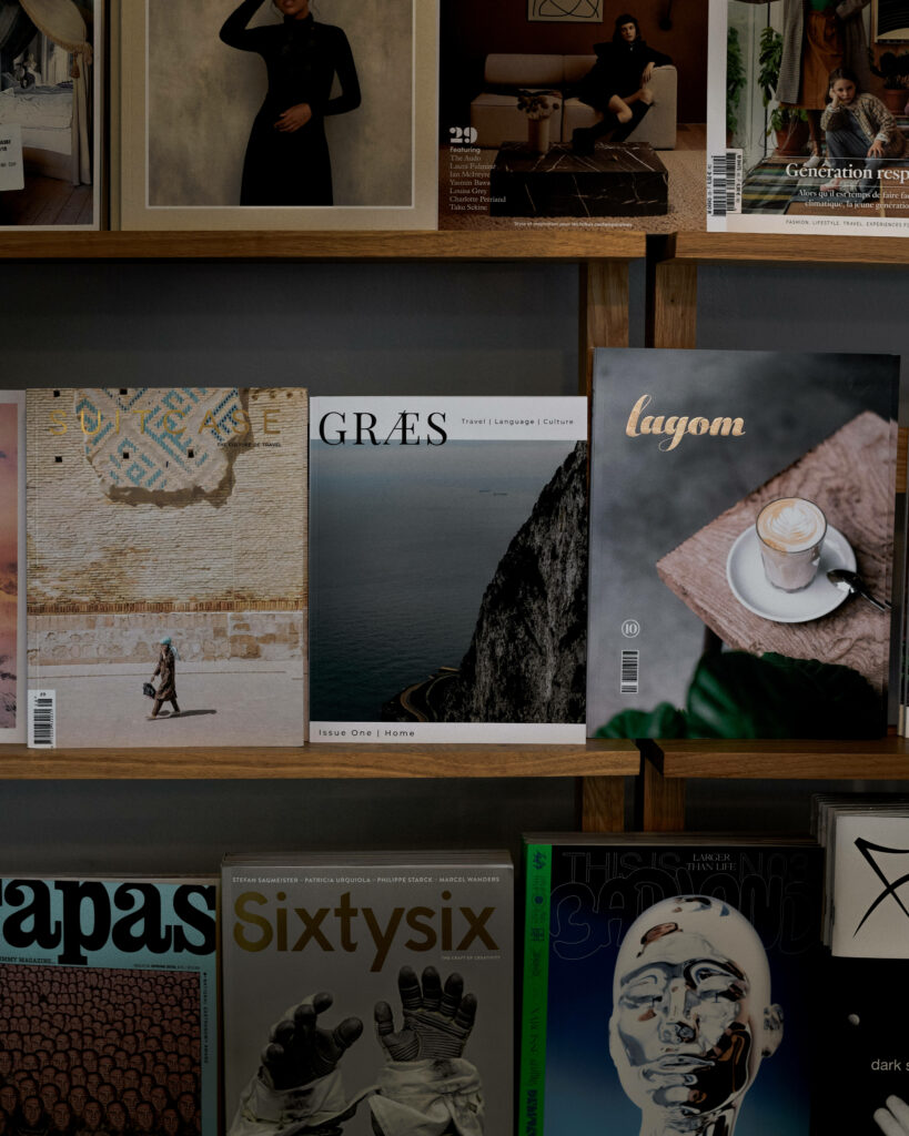 Captivating Composition: Indie Book Covers Gracefully Nestled on a Rustic Wooden Shelf Wallpaper