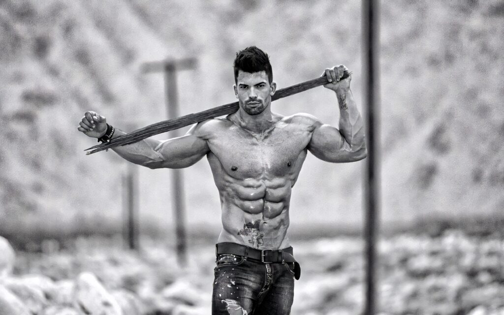 Sergi Constance shirtless outdoors showing muscular physique holding wooden stick bodybuilding wallpaper