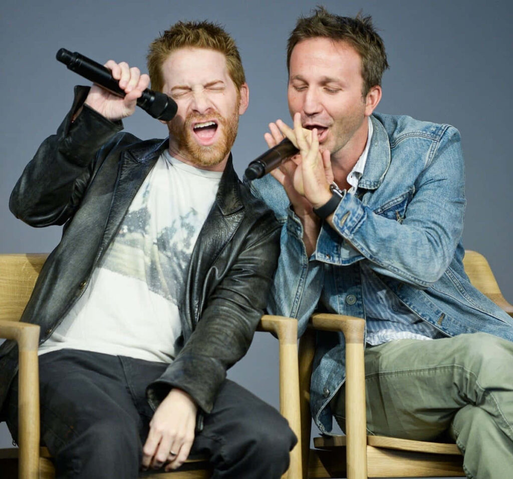Seth Green and Breckin Meyer singing on stage energetic performance leather and denim jackets Wallpaper