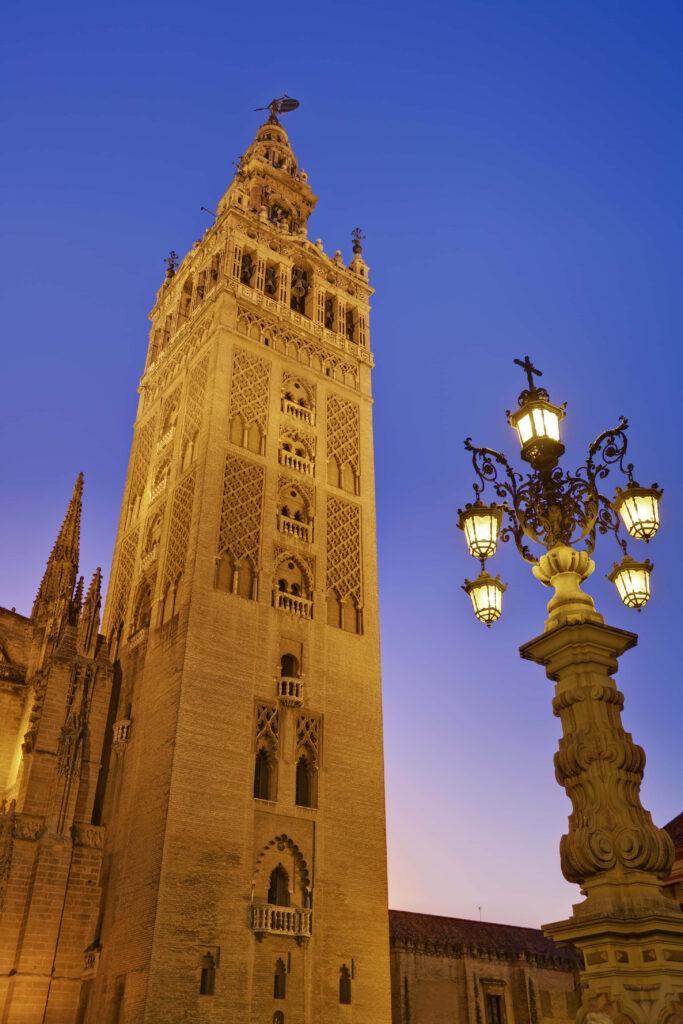 Sunset Seville Cathedral Bell Tower Wallpaper with Charming Street Lamp