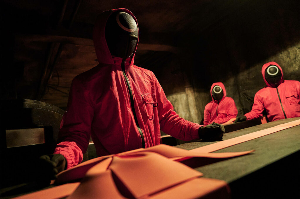 Guarding the Shadows: A Surreal Encounter with Coffins and Ribbons Wallpaper