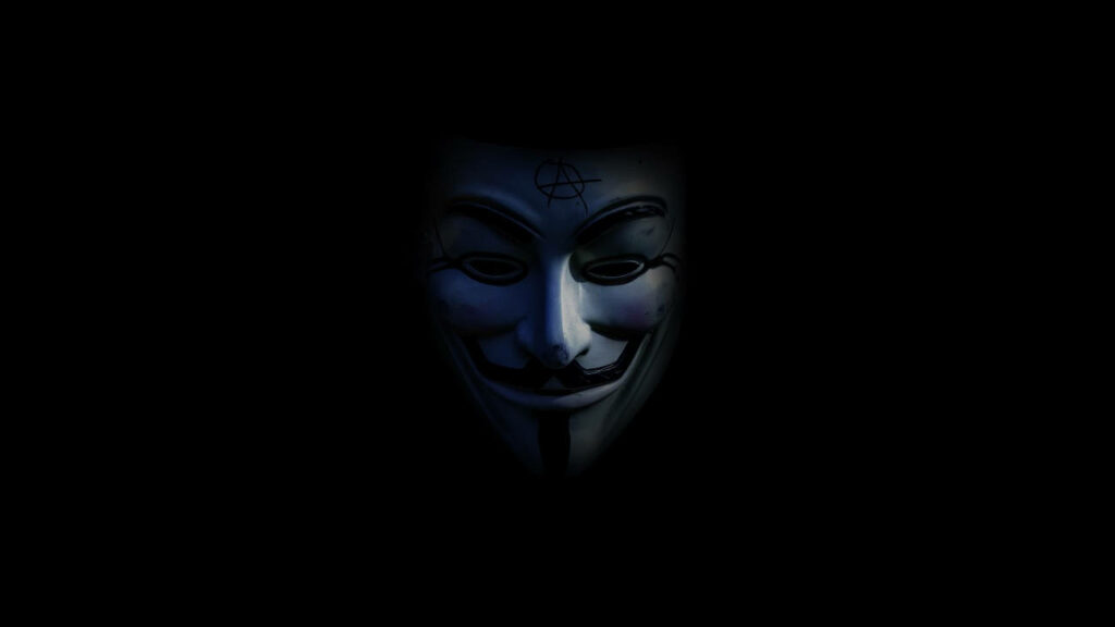 Shadowed Persona: The Enigmatic Anonymous with Fawkes Mask - A Dark PC Background Wallpaper