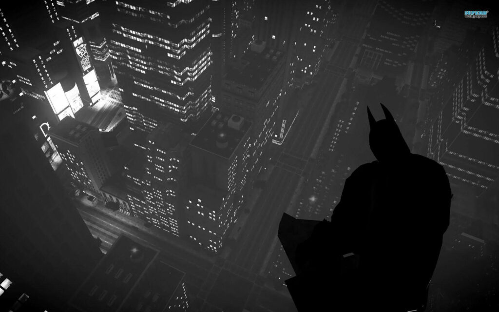 Brooding Guardian: Batman's Silhouette Over Dark Cityscape - Enigmatic PC Wallpaper