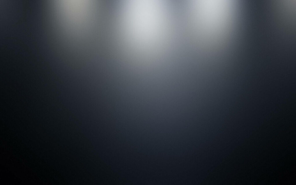 Minimalist dark gradient wallpaper in jet black onyx and charcoal with soft top lighting