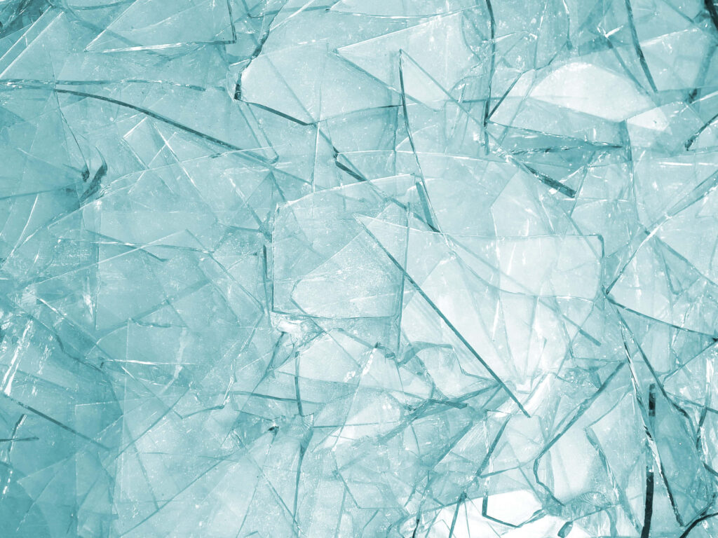 Broken glass wallpaper with intricate blue shards and crystalline textures on dark background