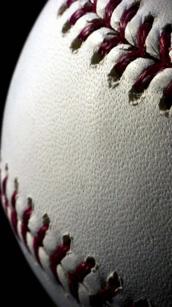 Close-up of white leather baseball with red stitching on dark background high detail wallpaper