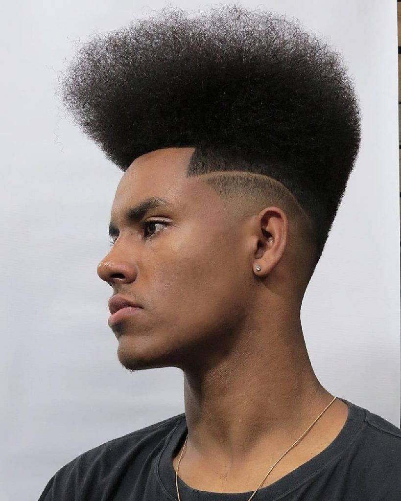 Sharp high top fade hairstyle on man with textured flat top in clean studio background Wallpaper