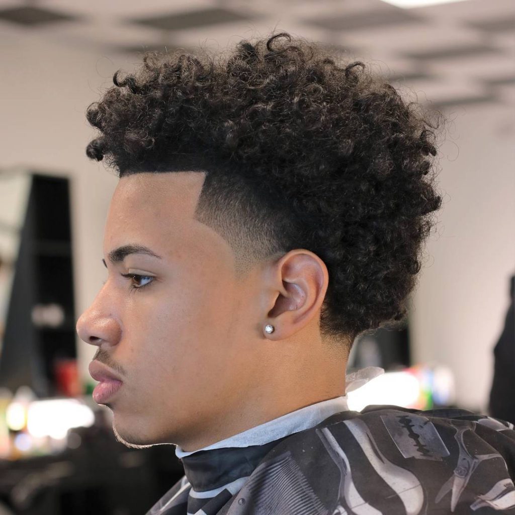 Man with fresh low drop fade and curly Afro hair showing sharp barber line-up and texture Wallpaper