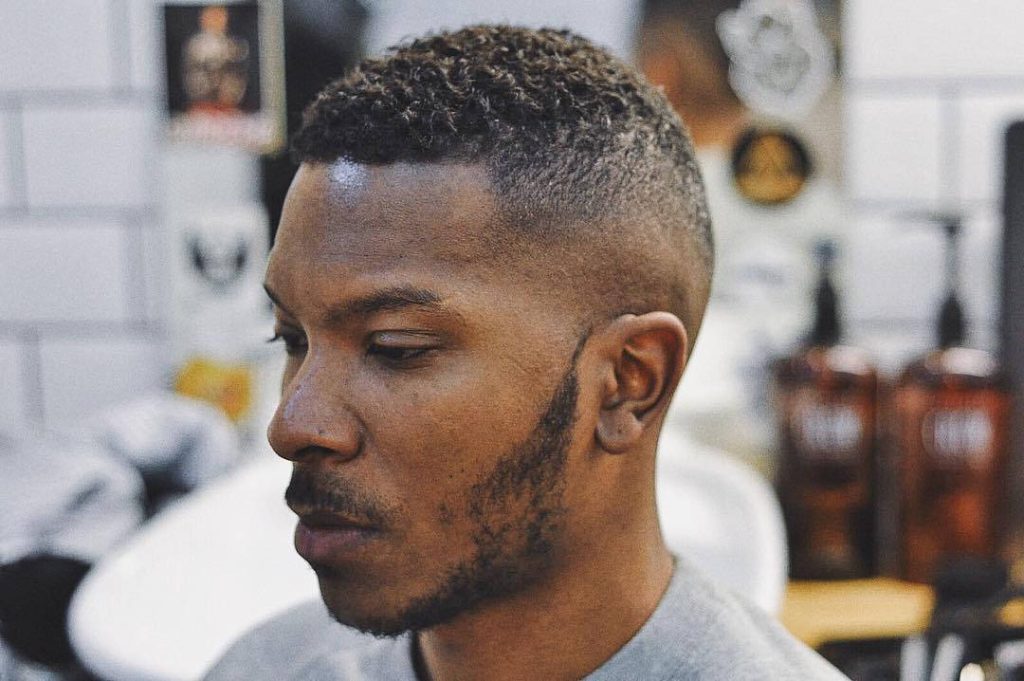 Sharp textured afro fade with precise taper high and tight haircut men hairstyle wallpaper
