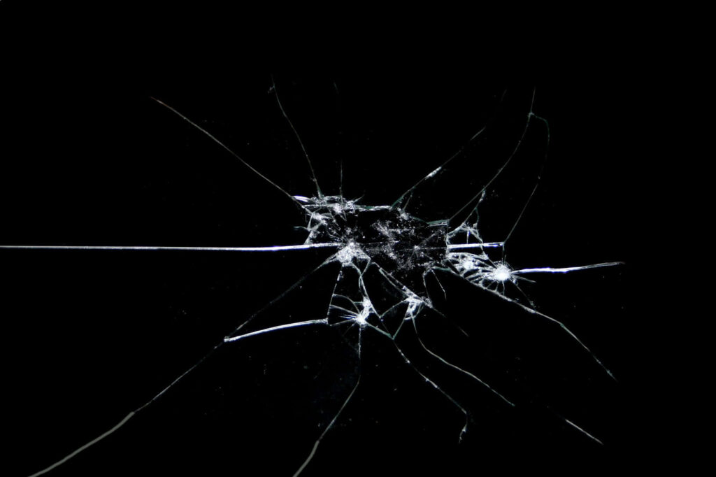 Close up of shattered glass shards on black background dramatic high resolution wallpaper image