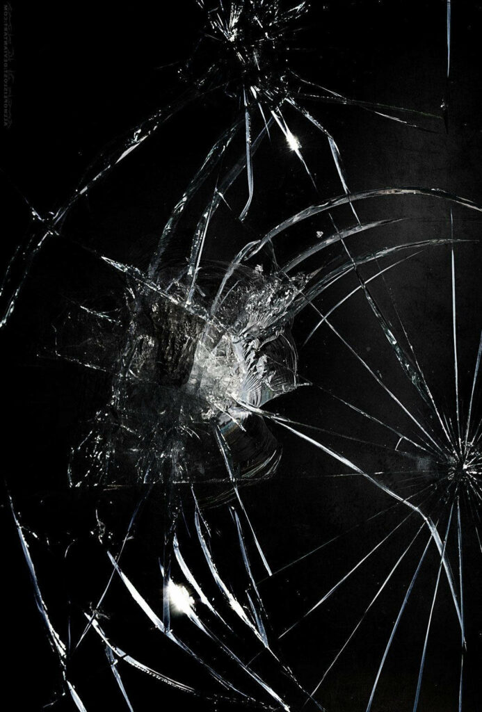 Shattered Dreams wallpaper with realistic broken glass cracks on dark background for edgy desktop