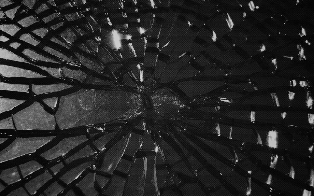 Shattered glass texture wallpaper with intricate cracks and dark monochrome broken glass effect background