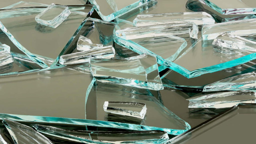 Broken glass wallpaper with sharp blue green shards reflecting light dynamic abstract design