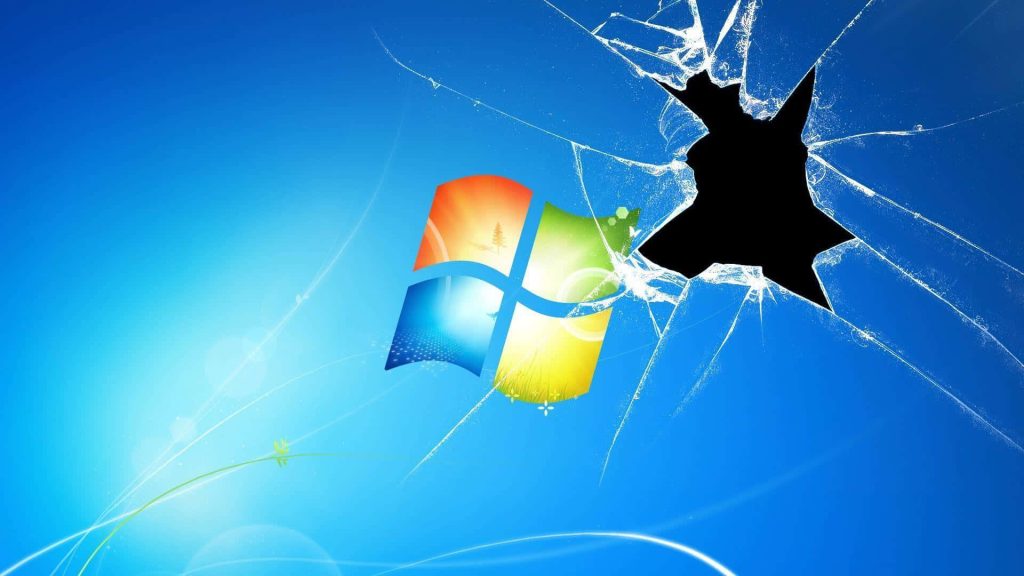 Shattered glass Windows Vista logo on smooth blue gradient background dark void wallpaper