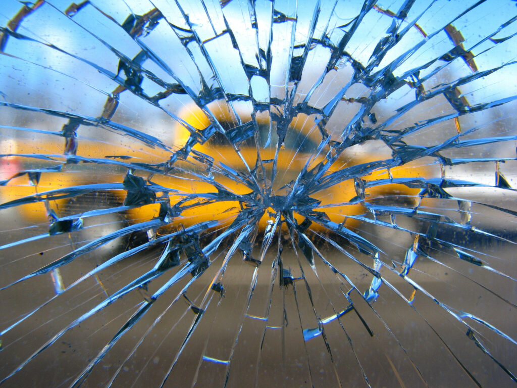 Shattered View: Broken Glass Window Frames Vibrant Automobile Wallpaper
