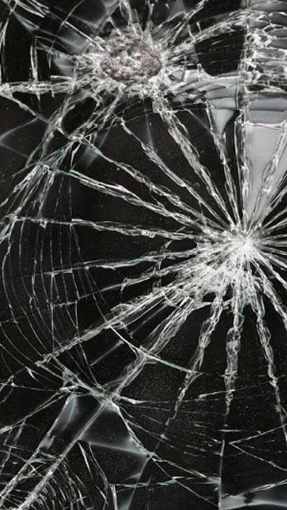 Shattered Digital Canvas: A Broken Computer Screen Wallpaper with Intricate Web-like Cracks