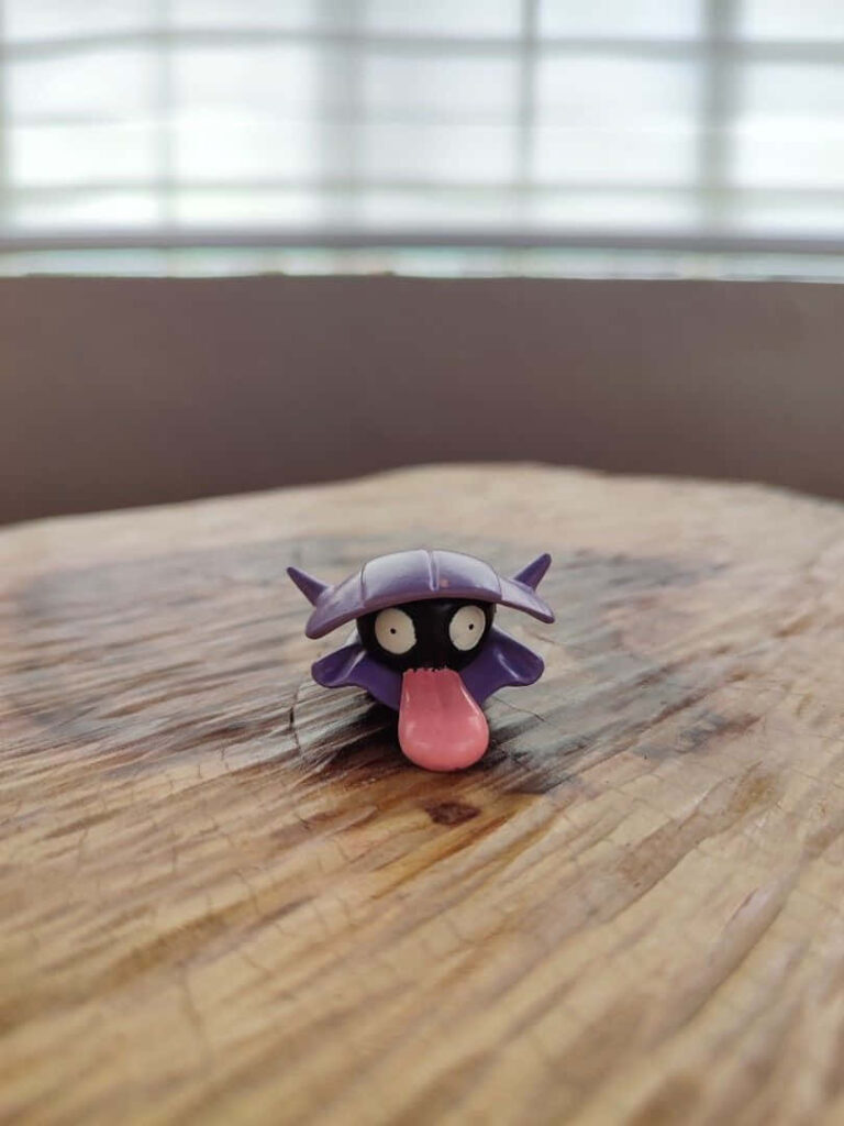 Charming Shellder Toy on Wooden Table with Soft Natural Lighting Wallpaper