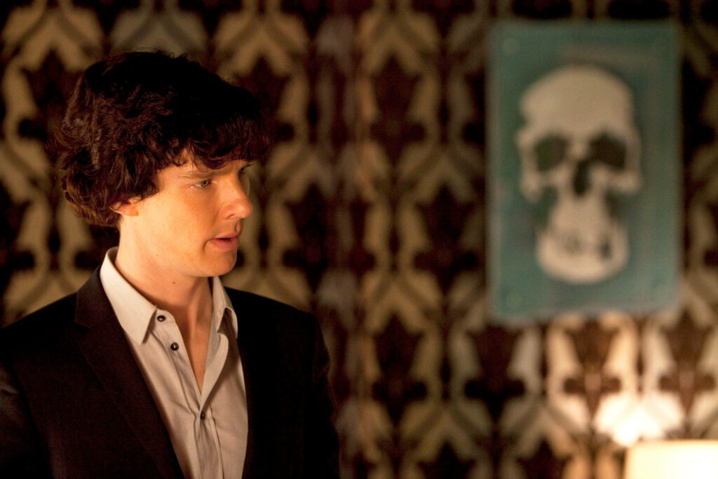 Sherlock Holmes Wallpaper: Contemplative Detective Against Patterned Wall