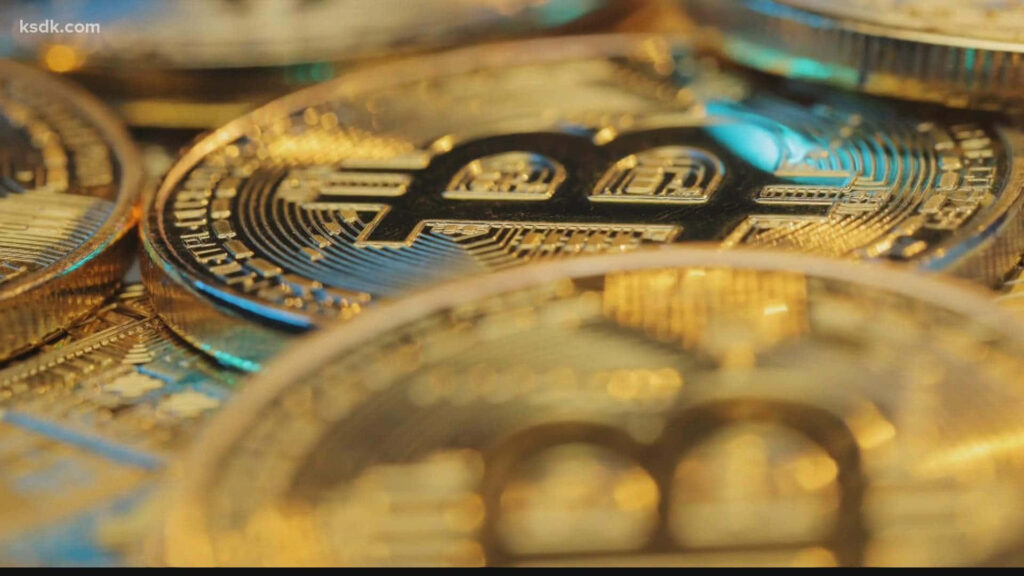 Close-up of shimmering gold Bitcoin coins representing digital currency and crypto investment background Wallpaper