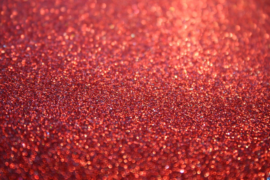 Fiery Shimmer: A Captivating Red Glitter Background Wallpaper