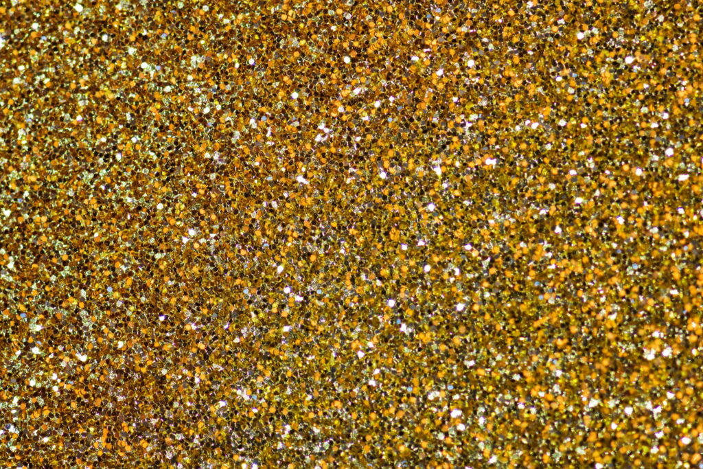 Glistening in Gold: A Stunning Glitter Wallpaper Background