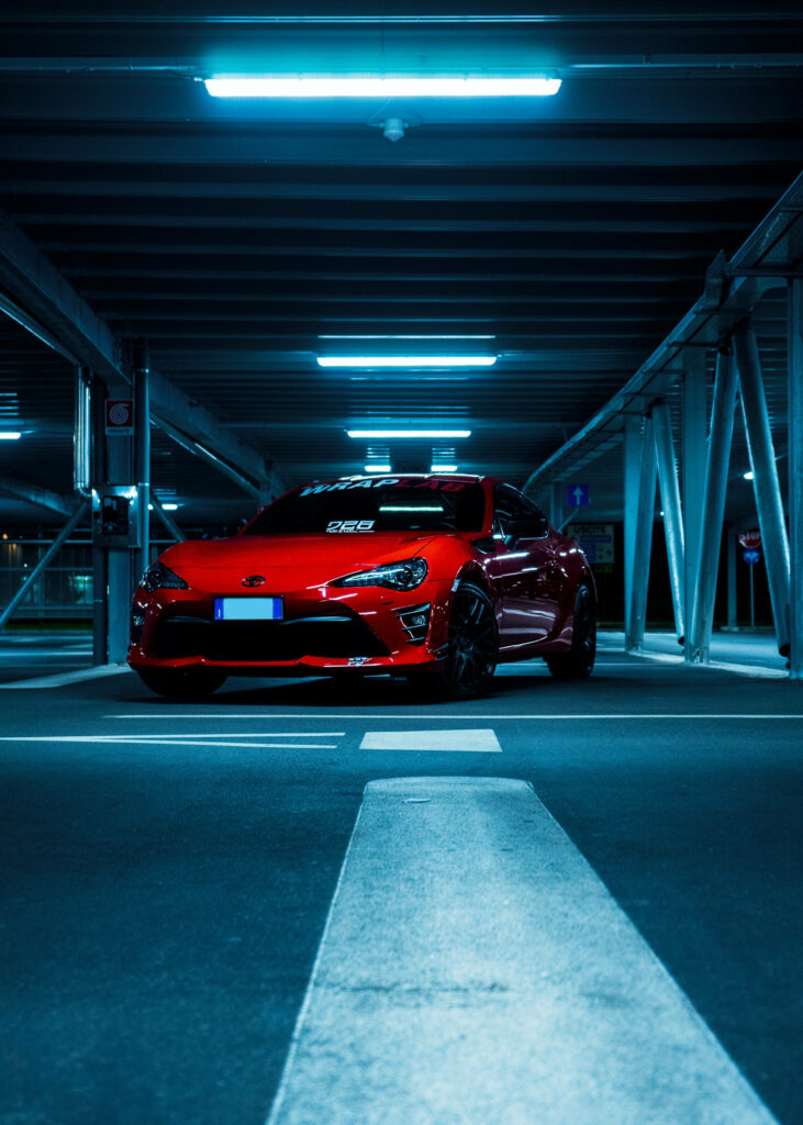 Speeding Elegance: Captivating Toyota Car in Metallic Red with Dazzling LED Illumination Wallpaper