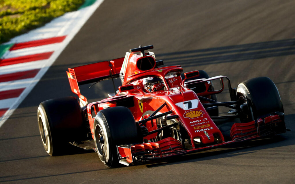 Speed, Brilliance, and Elegance: Ferrari F1 2018 Shines Under Sunlight on the Race Track Wallpaper