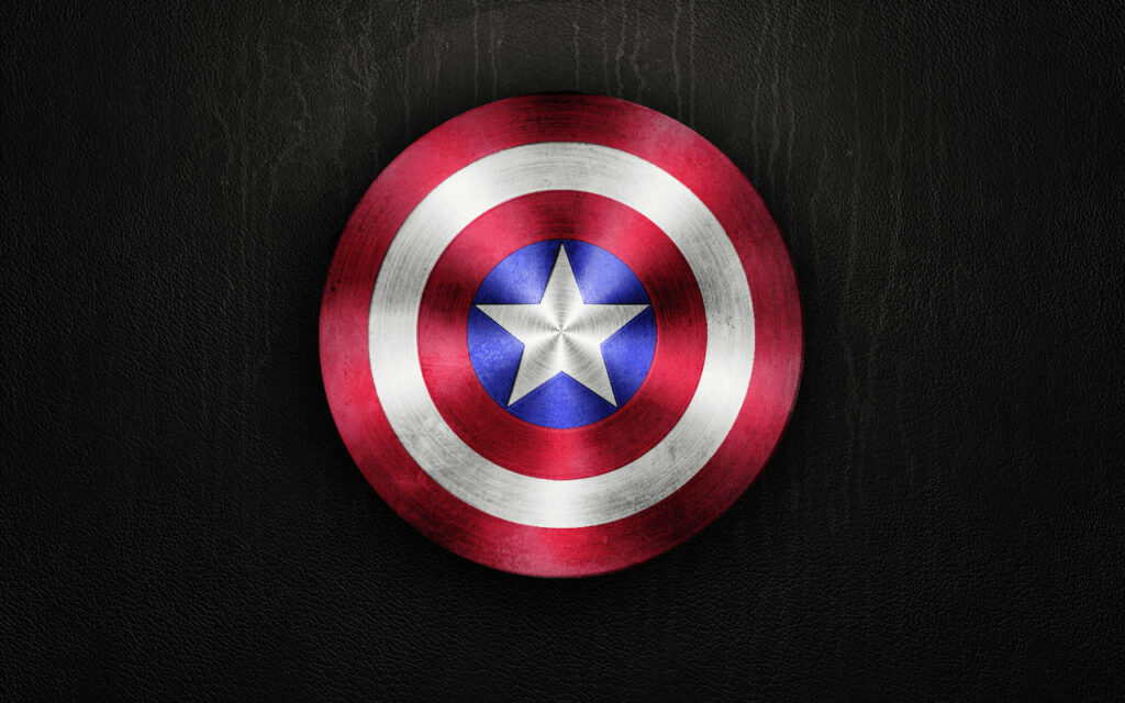 Gleaming Captain America Shield Radiates Heroic Brilliance on Dark Canvas Wallpaper