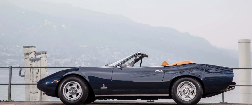 Glistening Black Beauty: Captivating Ferrari 365 Showcasing Elegance amidst Scenic Rails and Misty Mountains Wallpaper