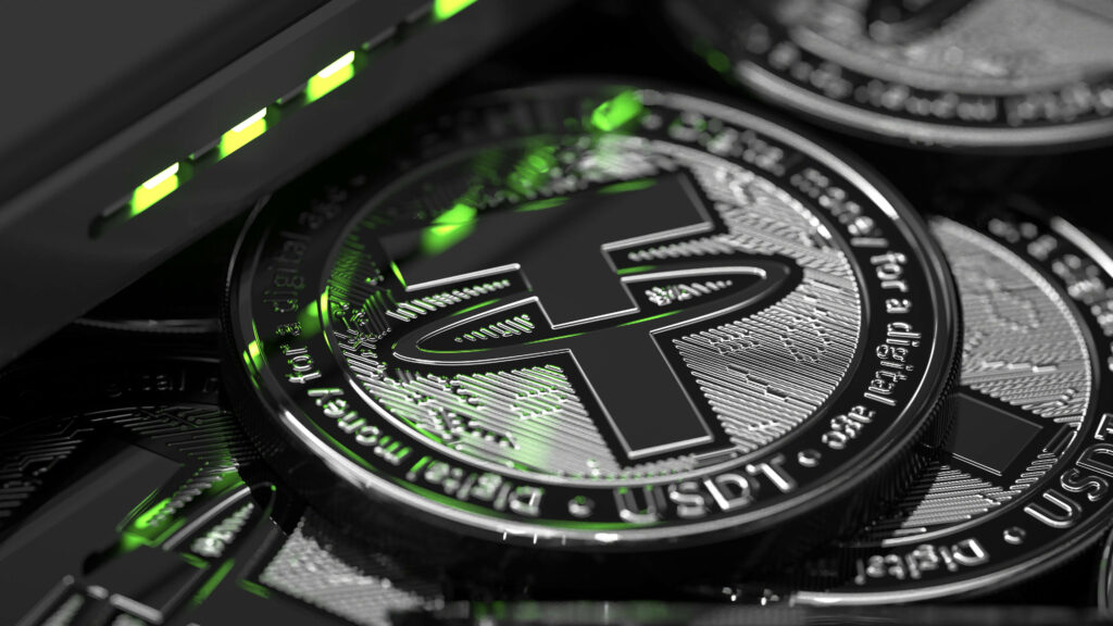 Close-up of shiny black Tether cryptocurrency coins illuminated by green LED lights wallpaper