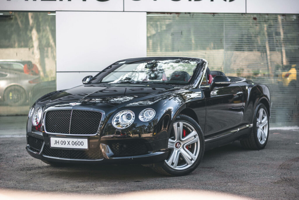 Convertible Bentley Car Glisten under Open Roofs in Scenic Backdrop Wallpaper