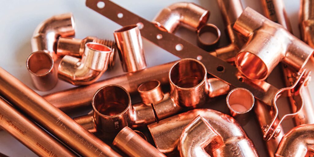 Shiny copper pipes and fittings with warm metallic tones industrial design wallpaper background