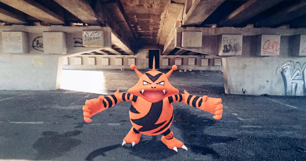 Shiny Electabuzz with bright orange stripes under highway overpass urban graffiti background wallpaper
