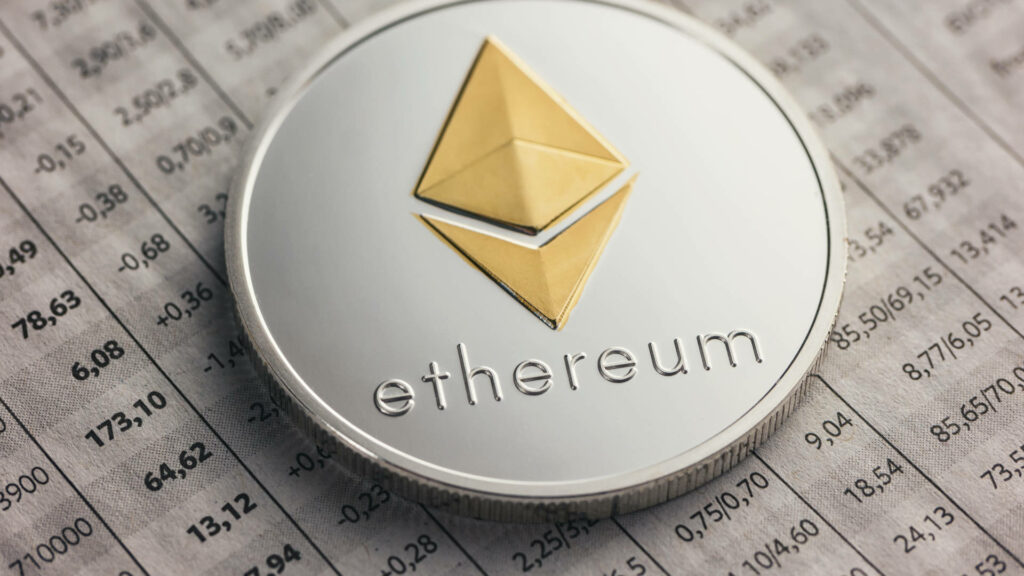 Shiny Ethereum coin with gold silver logo on detailed market price sheet digital finance trading Wallpaper
