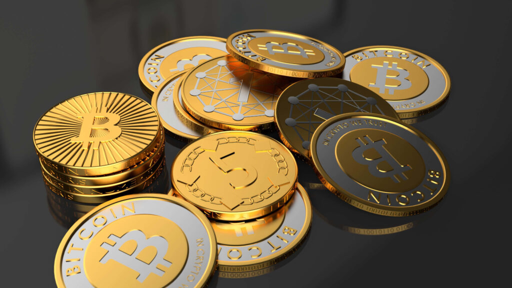 Shiny gold Bitcoin coins scattered on reflective black surface digital cryptocurrency wallpaper