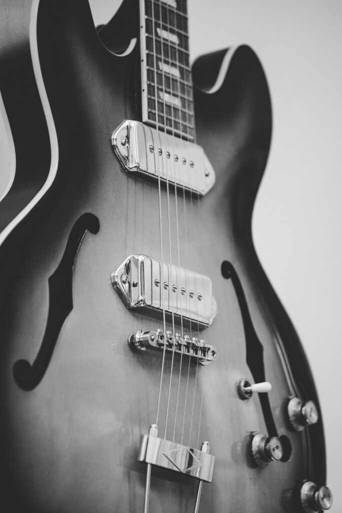 Strings and Strains: A Monochrome Melody of Guitar Components Wallpaper