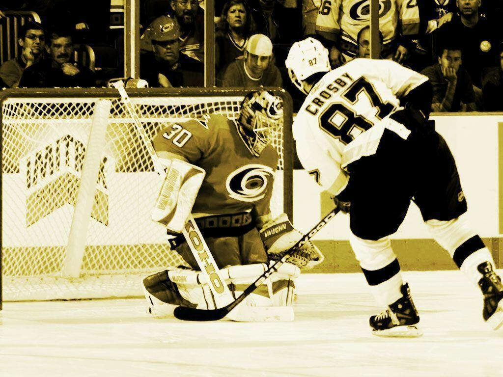 Sidney Crosby in Action: Intense Ice Hockey Match Wallpaper