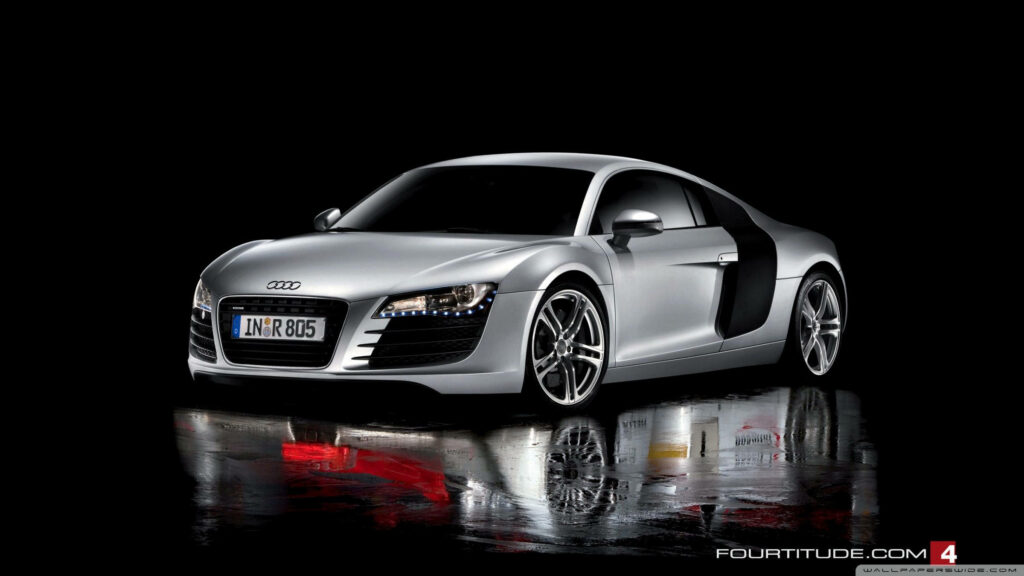 Silver Audi R8 sports car with aerodynamic design and bold alloy wheels on black background Wallpaper