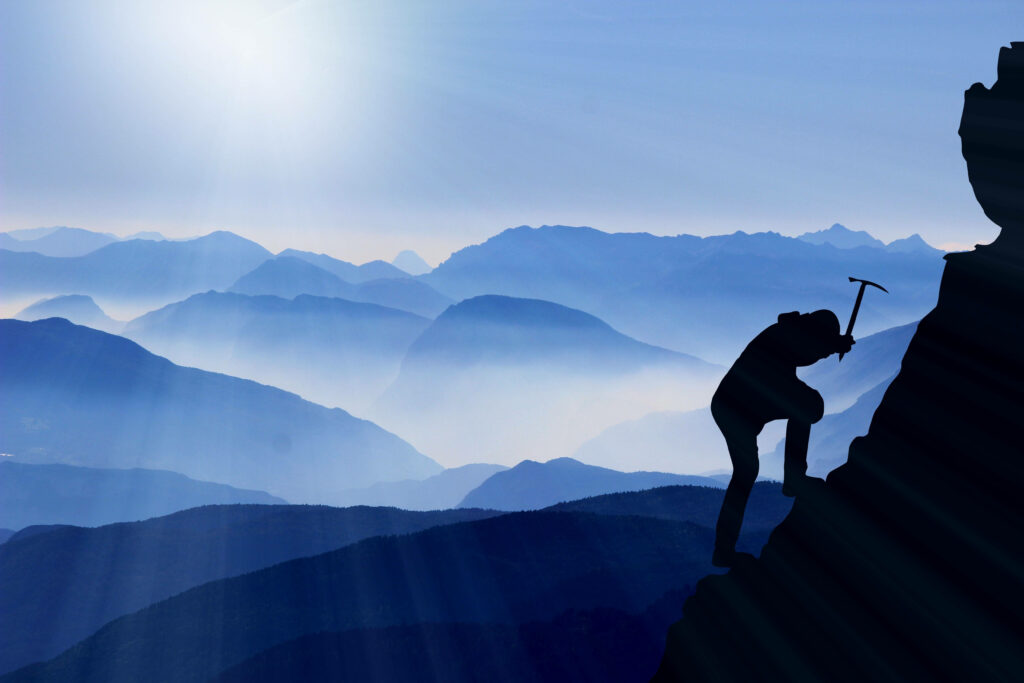 Silhouette of climber ascending steep mountain with ice axe layered blue mountains sky vector art Wallpaper