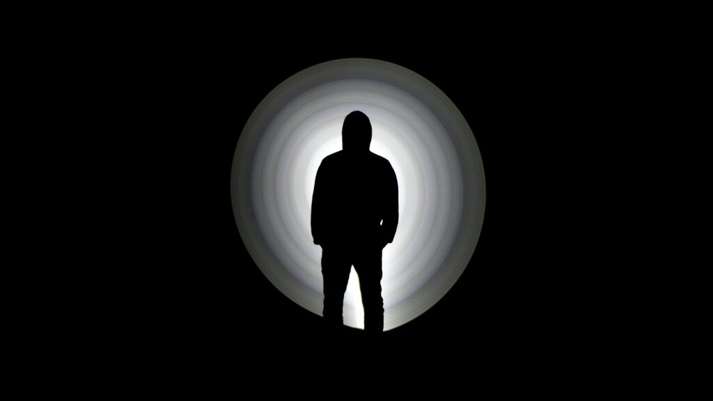 Silhouette of Man on Circular Gradient Background - Dramatic Wallpaper