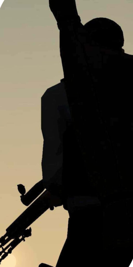 Silhouetted Lone Warrior: Battle Amidst a Vibrant Yellow Palette Wallpaper