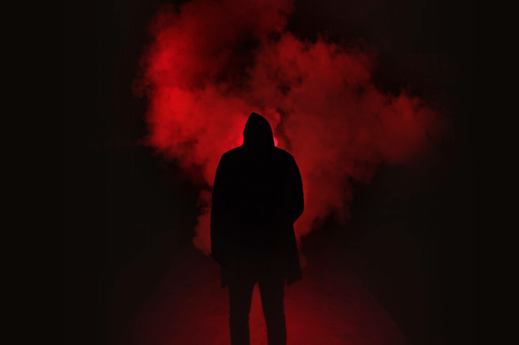 Bold Silhouette Emerges Amidst Enchanting Black and Scarlet Haze Wallpaper