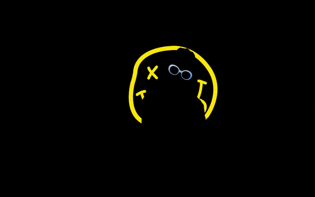 Nirvana Spirit: A Mesmerizing Silhouette Depicting a Member against a Smiley Logo on a Stylish Black Background Wallpaper