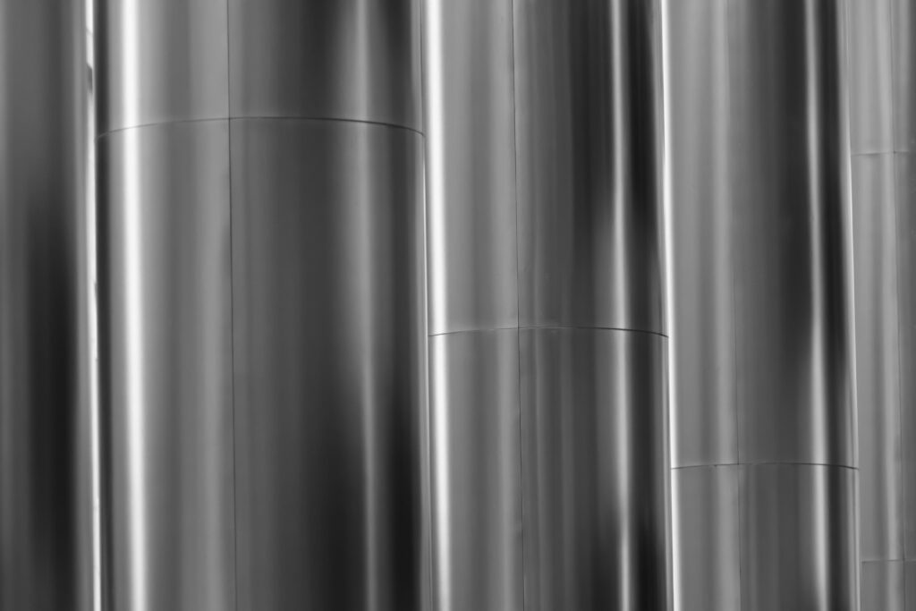 Minimalist HD wallpaper with sleek metallic columns and soft silver grey gradients background